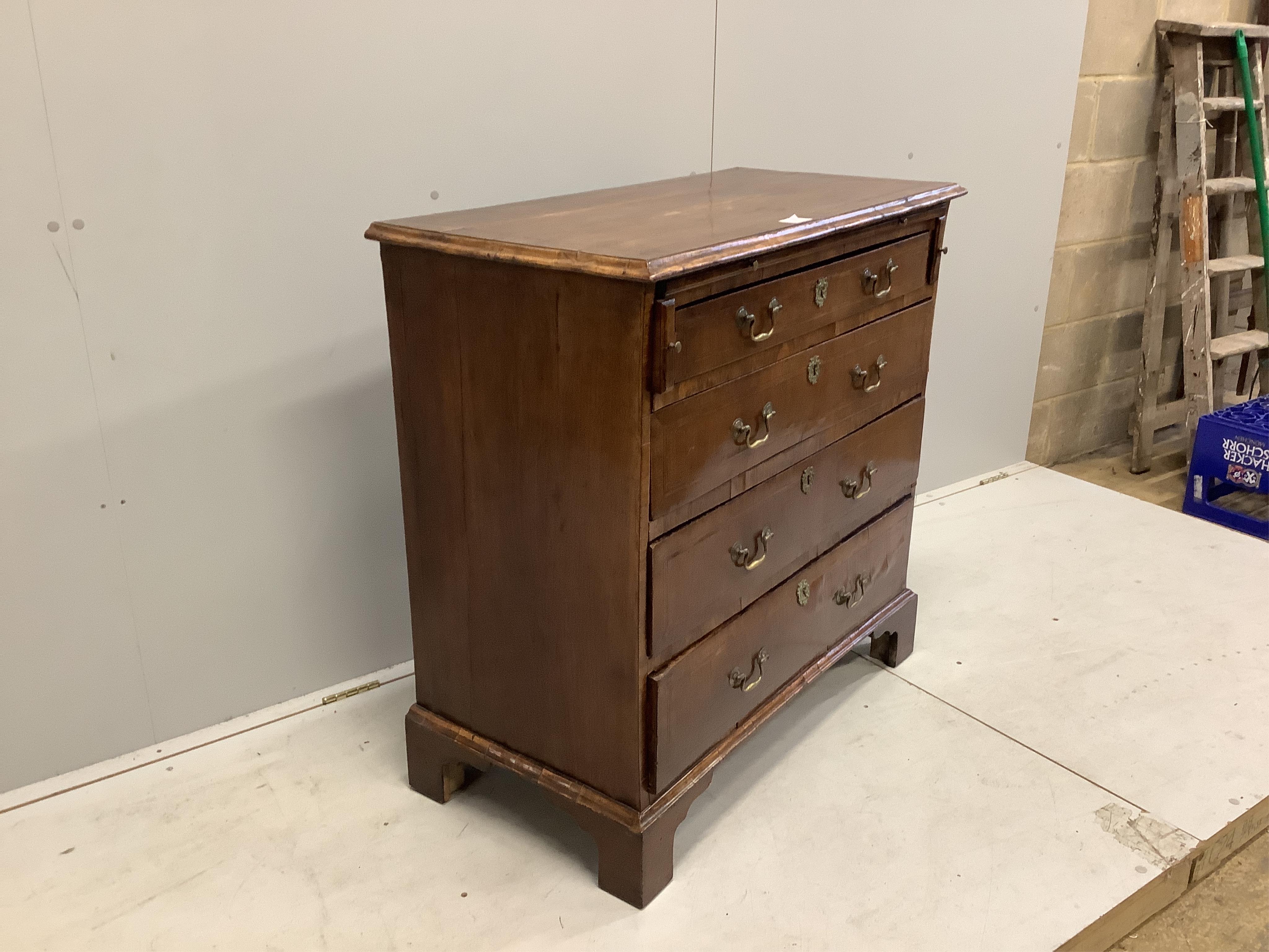 A mid 18th century feather banded walnut chest, fitted four long drawers, beneath a brushing slide, width 92cm, depth 48cm, height 92cm. Condition - fair